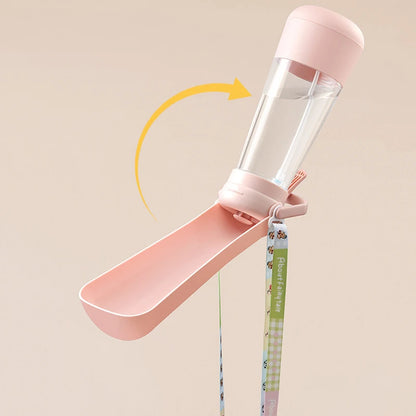 Pink 2-in-1 dog water bottle with rotating fold-out bowl and leash strap attached
