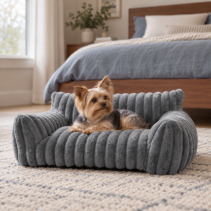 Yorkie resting on a gray plush pet sofa bed for small dogs and cats